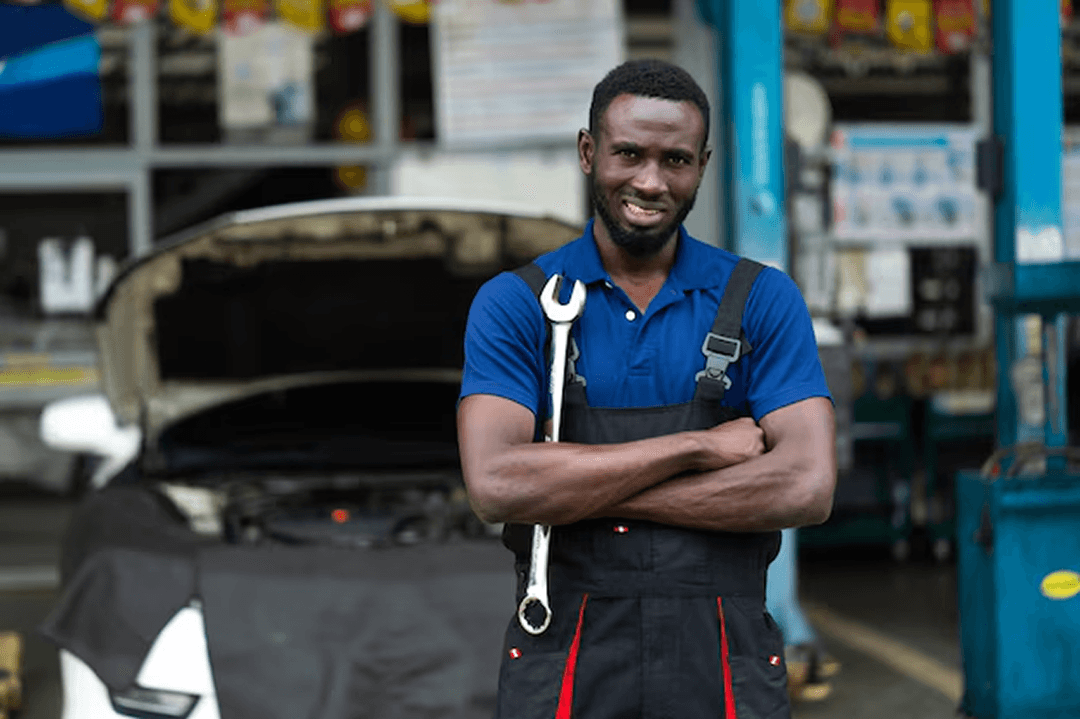 Certified mechanic with wrench in auto repair shop